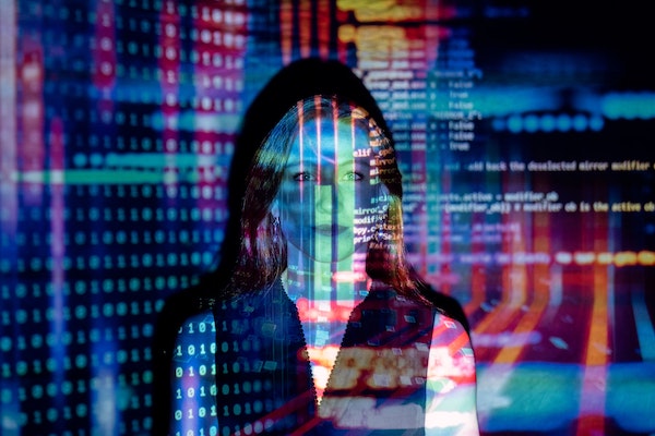 Woman silhouette overlaid with colorful digital code representing business digitalization