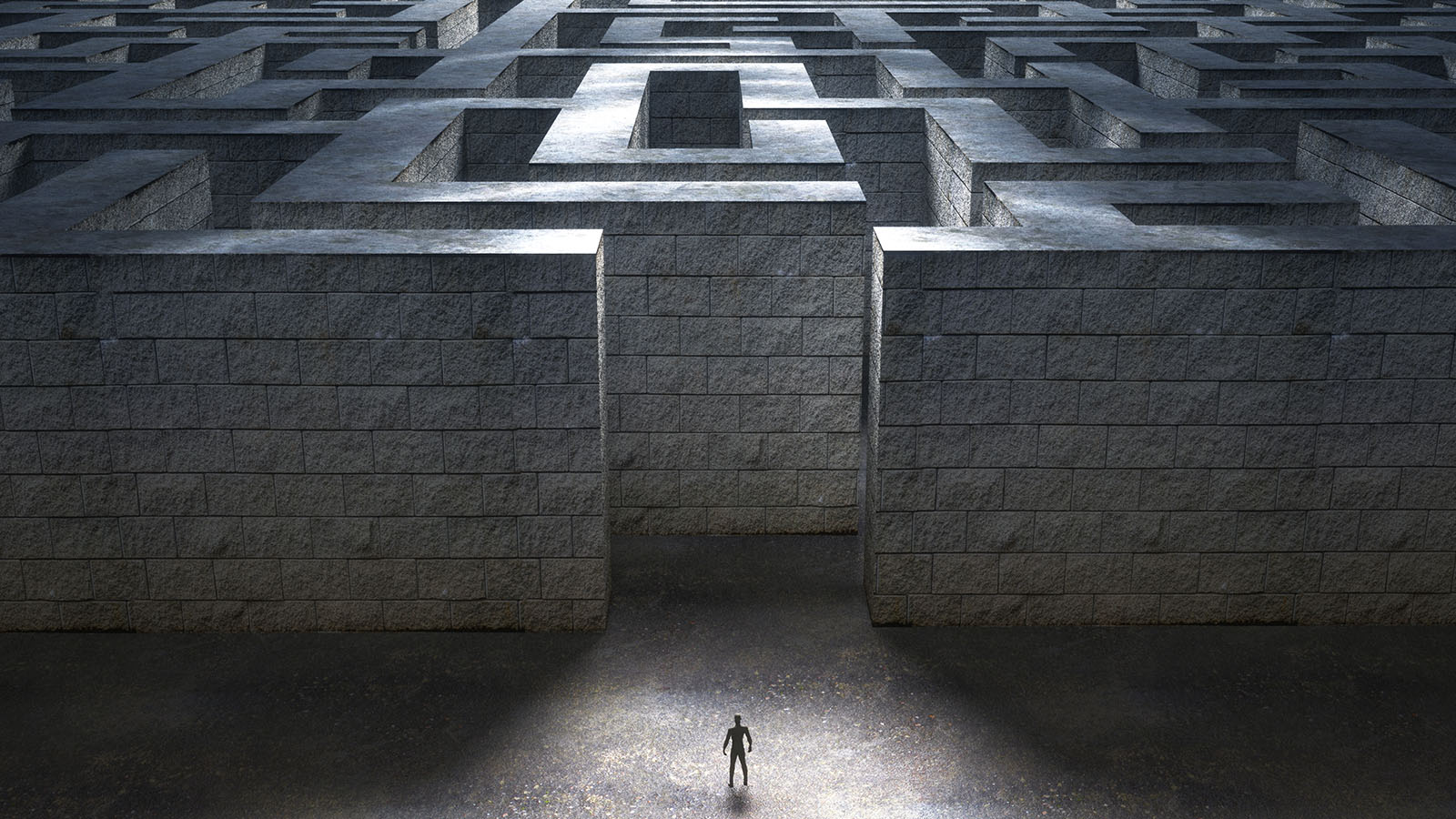 Small figure standing at the entrance of a massive stone labyrinth representing security challenges